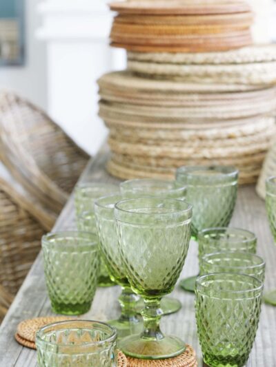 green tinged glassware and woven placemats