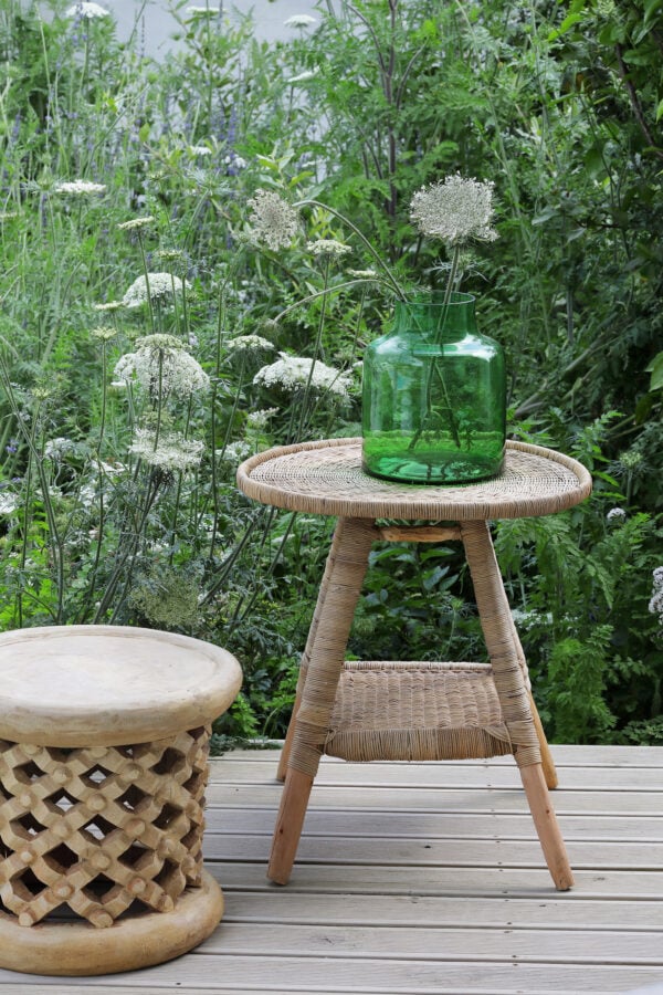 natural woven table with vase and bamileke stool as a side table