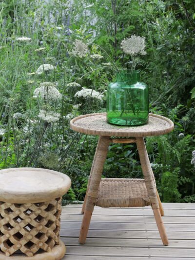natural woven table with vase and bamileke stool as a side table