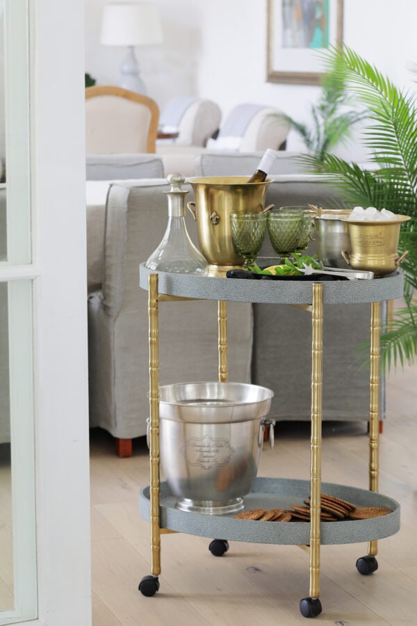 bar cart styled with champagne and glassware