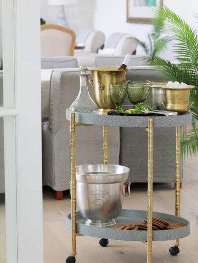 bar cart styled with champagne and glassware