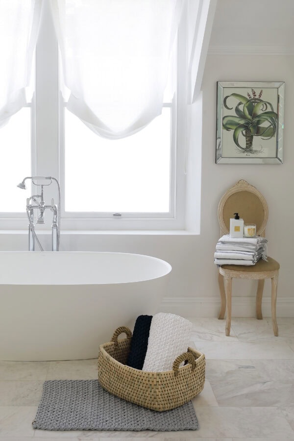 Lifestyle image of a white and light bathroom with Summer Vineyard Liquid Soap