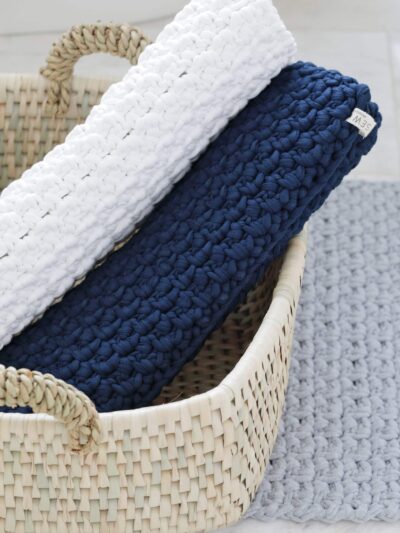 crochet bath mat rolled up in basket