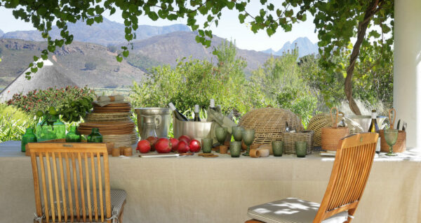 Lifestlyle table setting with glassware, rattan baskets and placemats